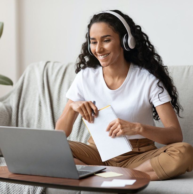 cheerful-lady-attending-online-course-using-laptop-and-wireless-headset.jpg digital bolt